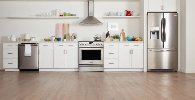 modern white kitchen with wood-look vinyl plank flooring